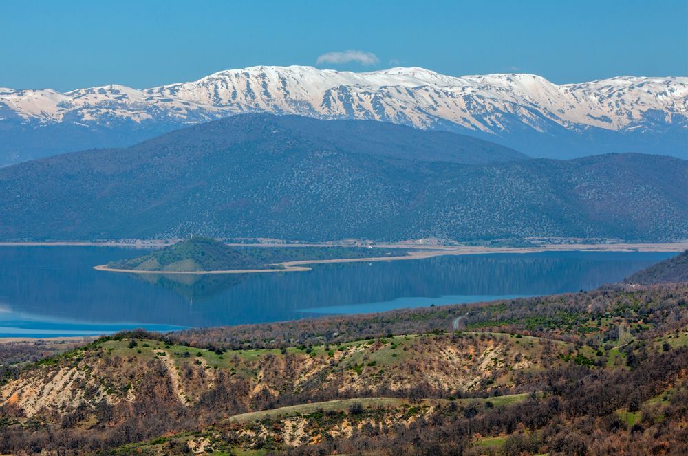 the little prespa lake under the snowy mountains