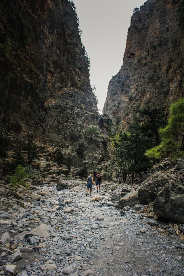 hikers crossing the lush gorge of Samaria in Crete