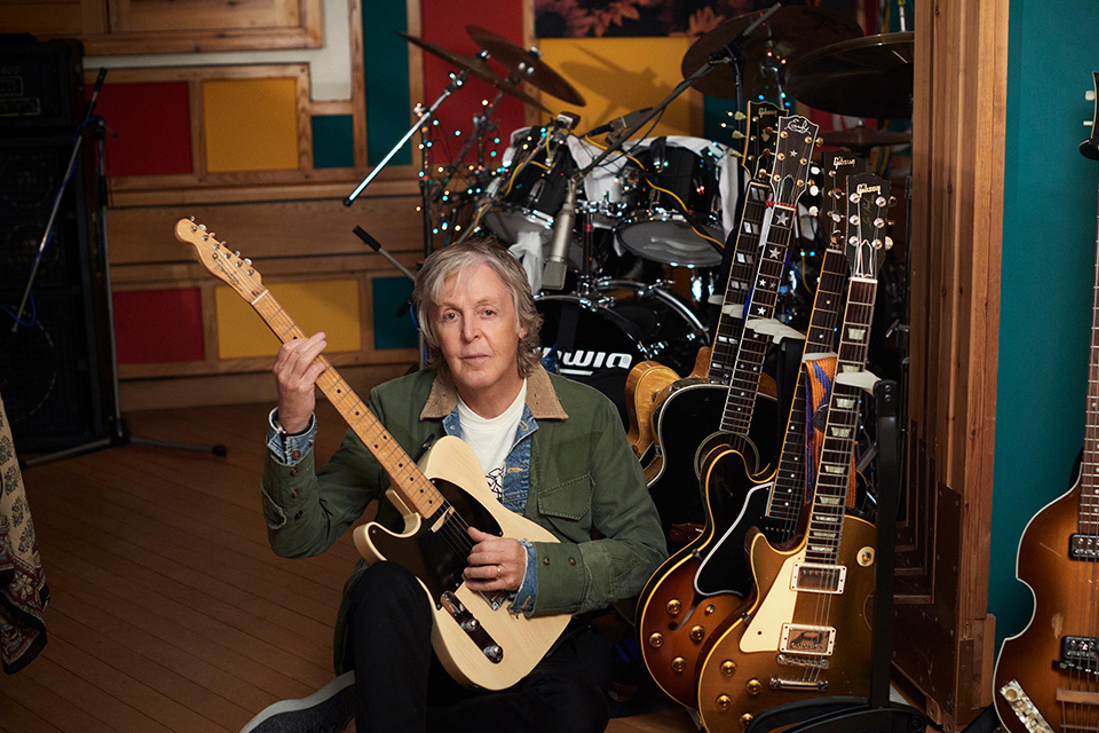 Photo of Paul at the guitar rack in his studio in Sussex during the recording of 'McCartney III'