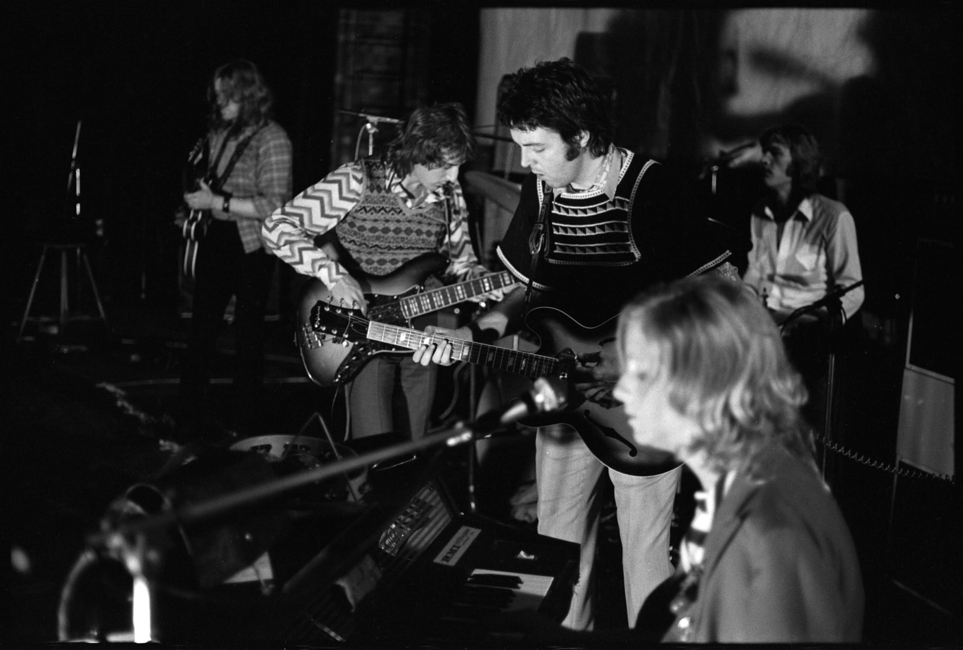 Black and white photo of Wings band members playing instruments