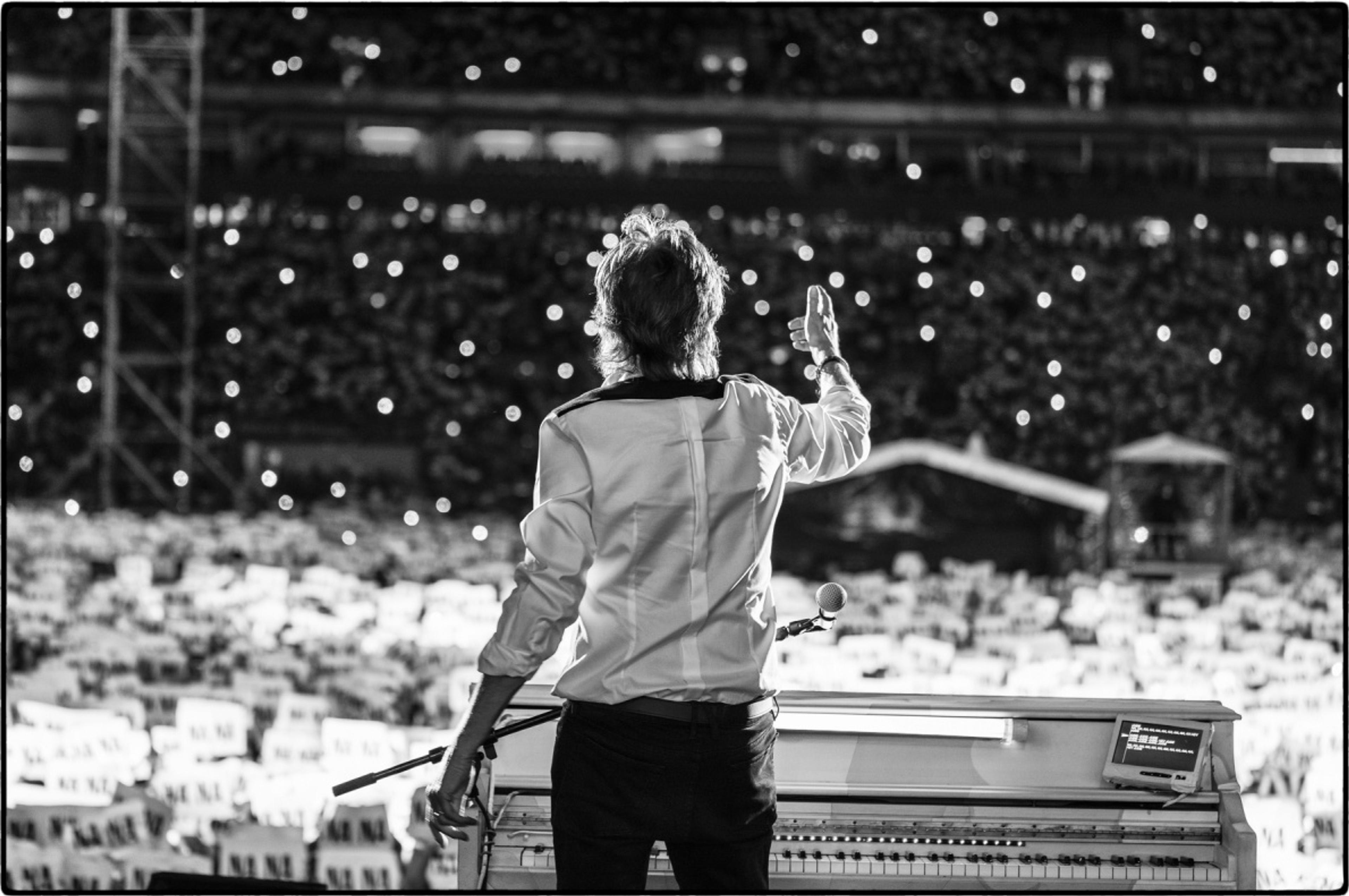 Fans hold up Na Na signs during Paul’s show at the Allianz Parque in Sao Paulo.