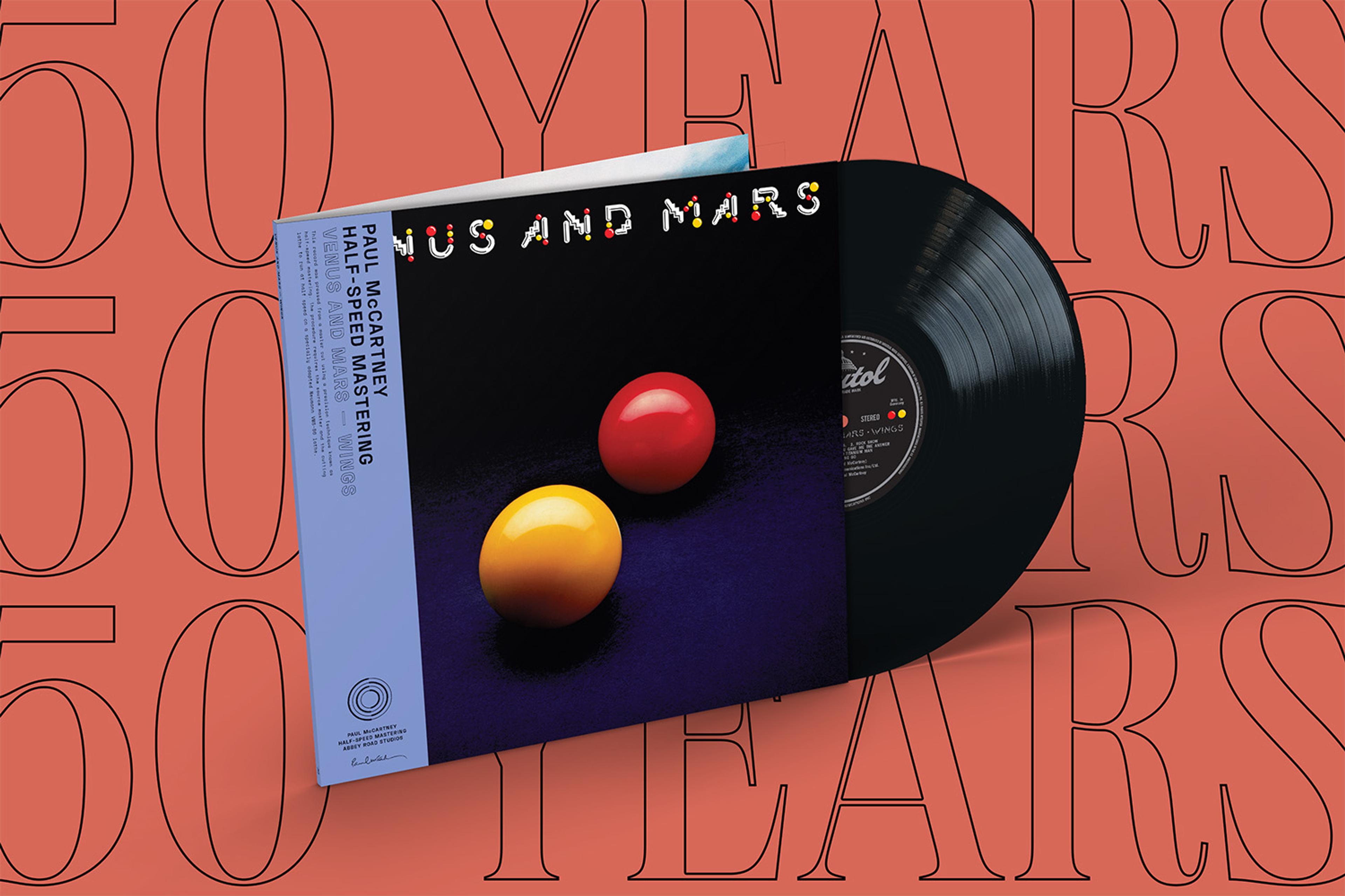 A promotional graphic featuring a special‑edition half‑speed‑master vinyl of Wings’ “Venus and Mars.” Underneath the record, bold graphic text repeats: “50 years.”