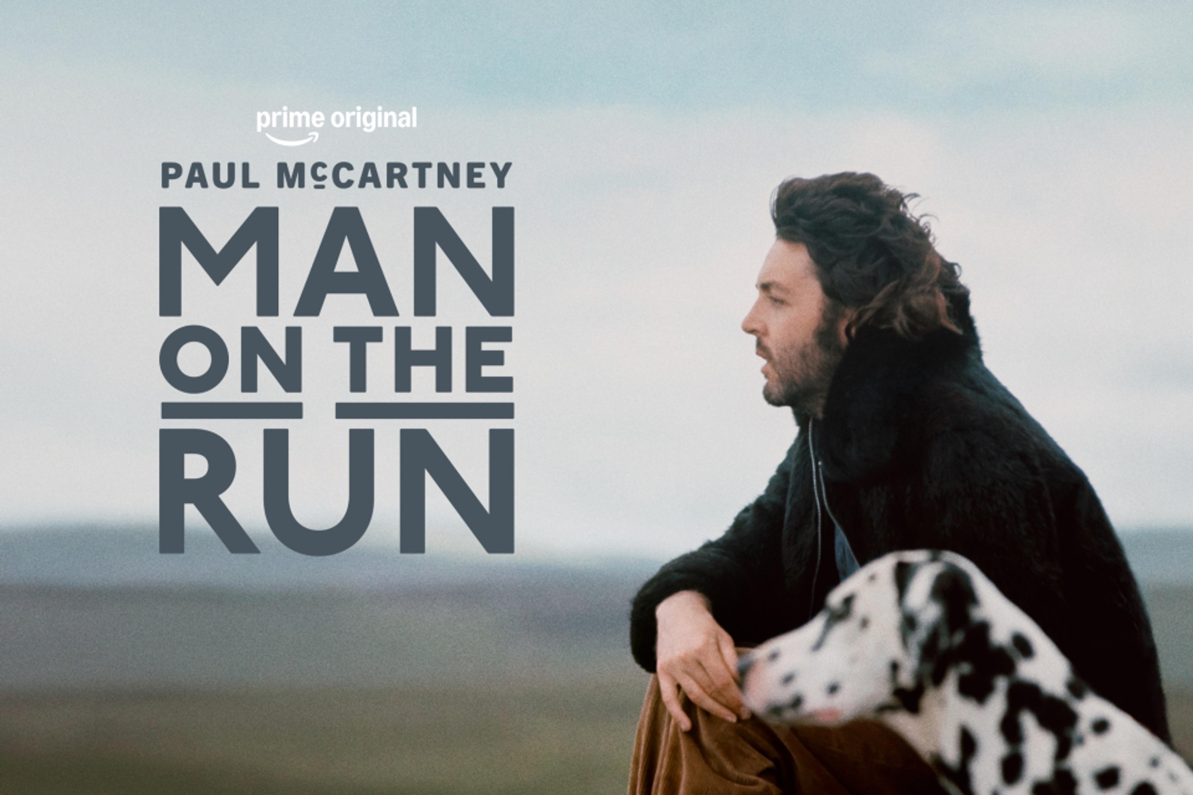 Paul sitting down with Lucky the Dalmatian dog. Displayed text reads 'MAN ON THE RUN'