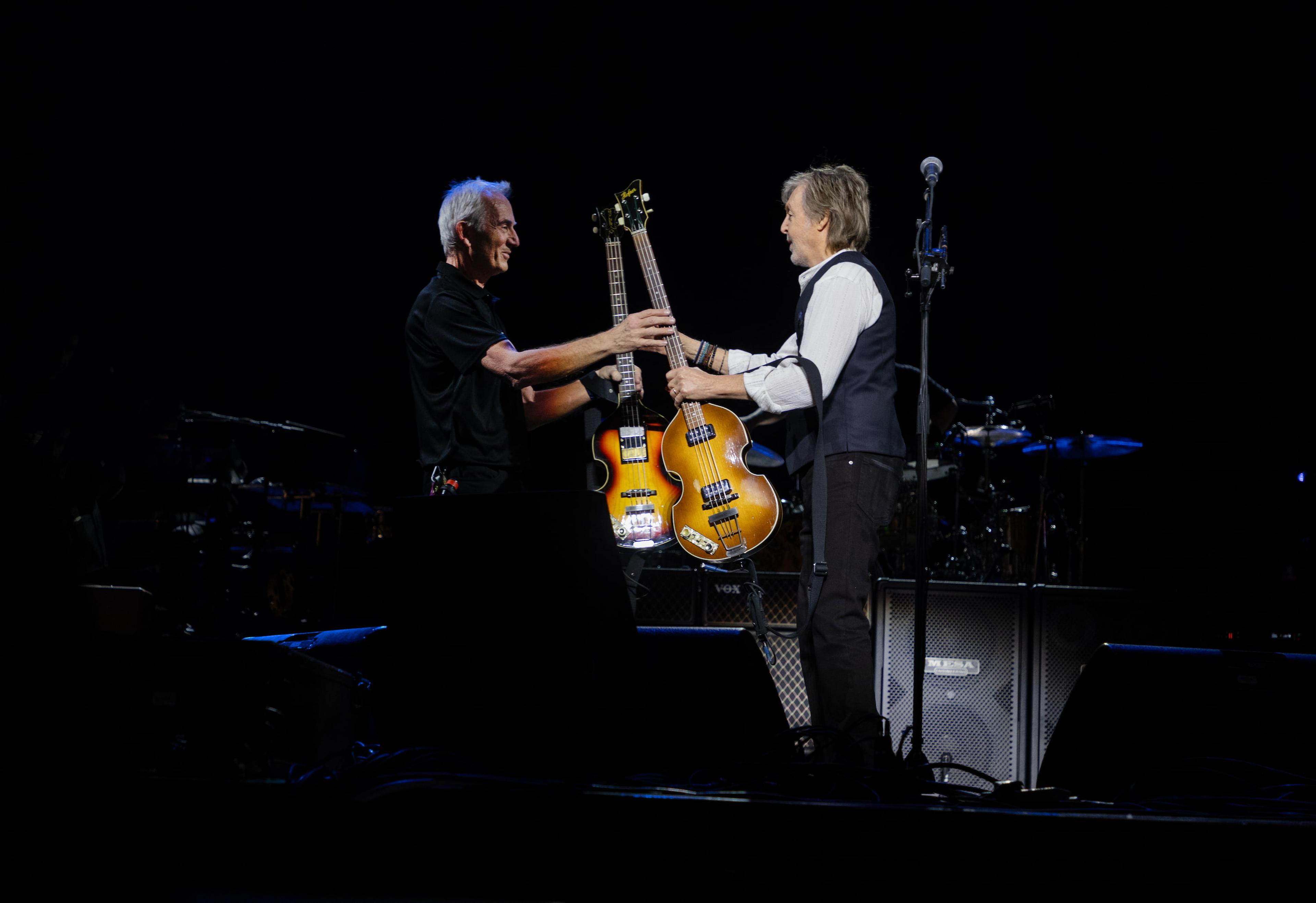  Paul McCartney stands on stage at London’s O2 Arena with technical manager Keith Smith as they swap his 1963 Höfner bass for the newly recovered 1961 Höfner.