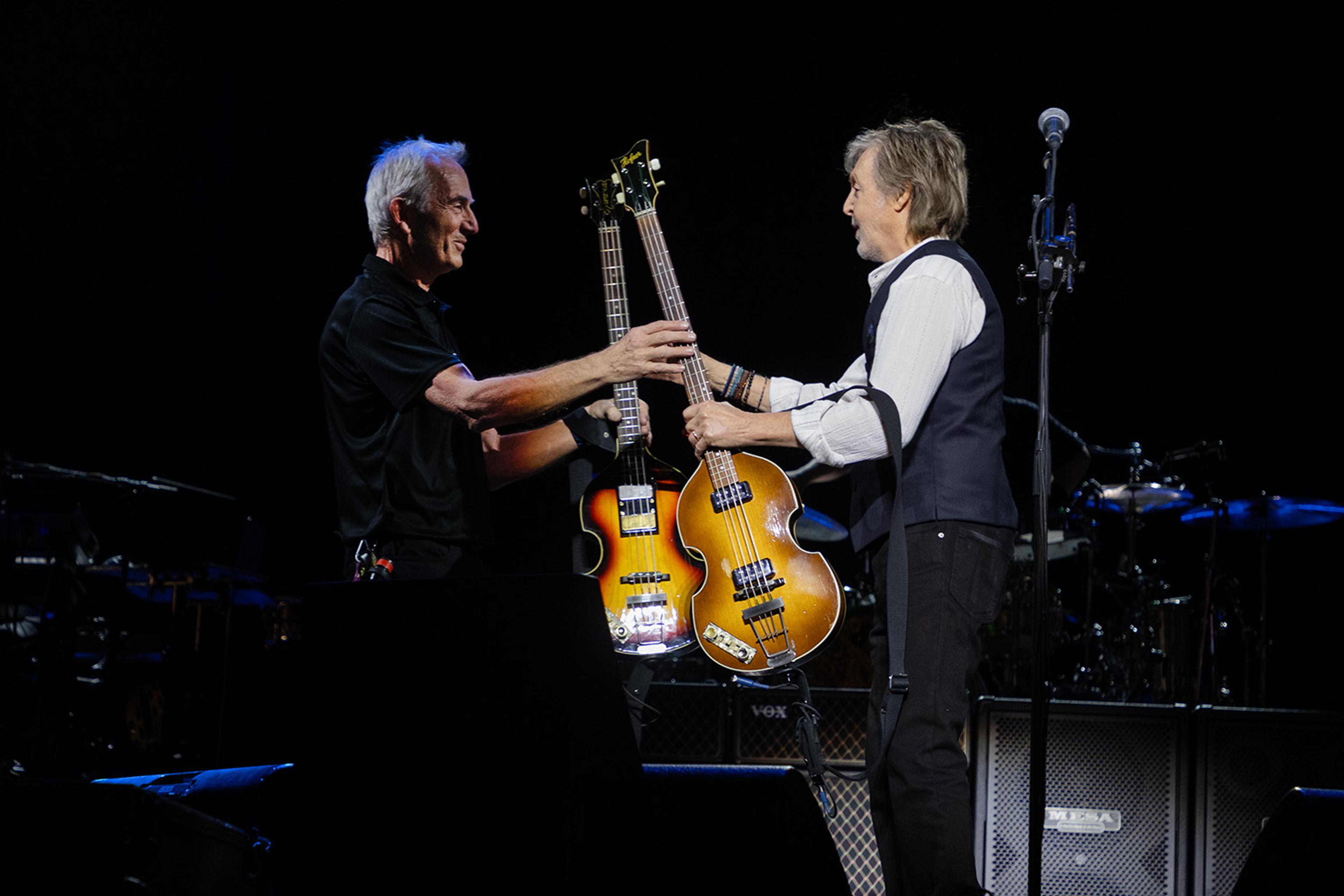  Paul McCartney stands on stage at London’s O2 Arena with technical manager Keith Smith as they swap his 1963 Höfner bass for the newly recovered 1961 Höfner.