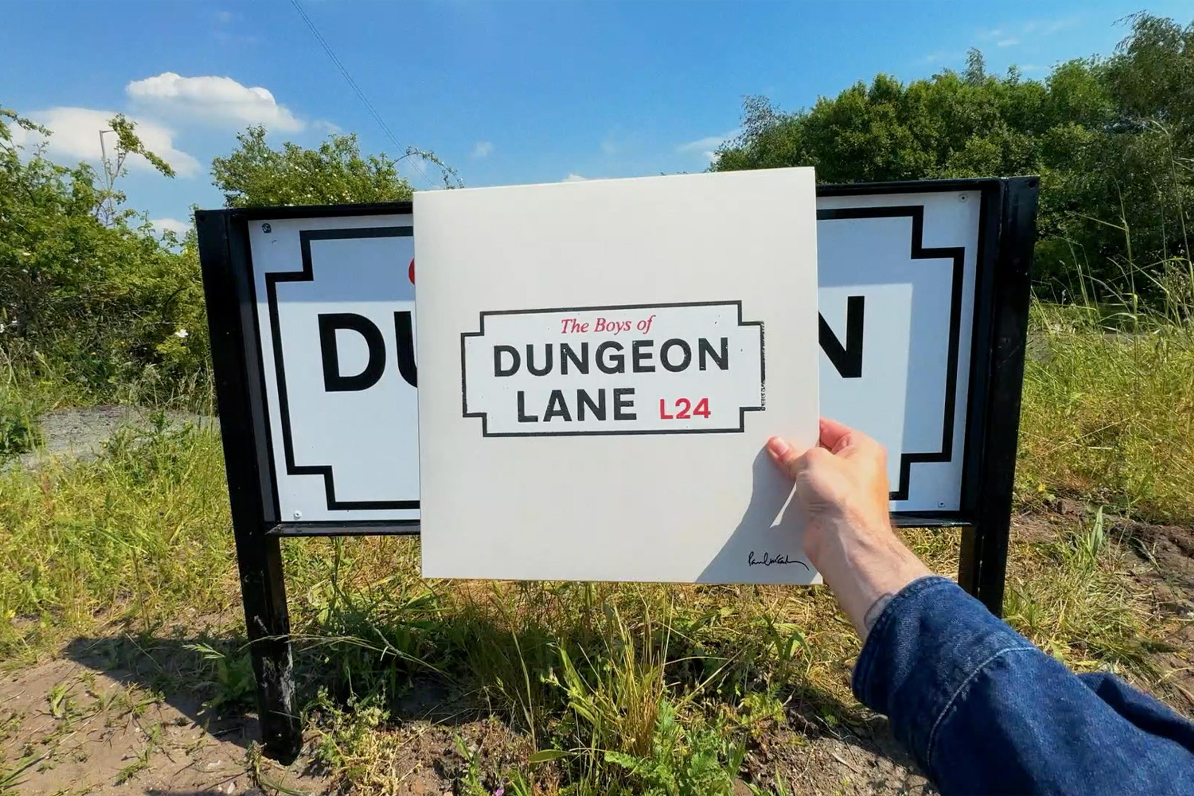 Photo of someone holding 'The Boys of Dungeon Lane' LP at the The Dungeon Lane sign in Liverpool