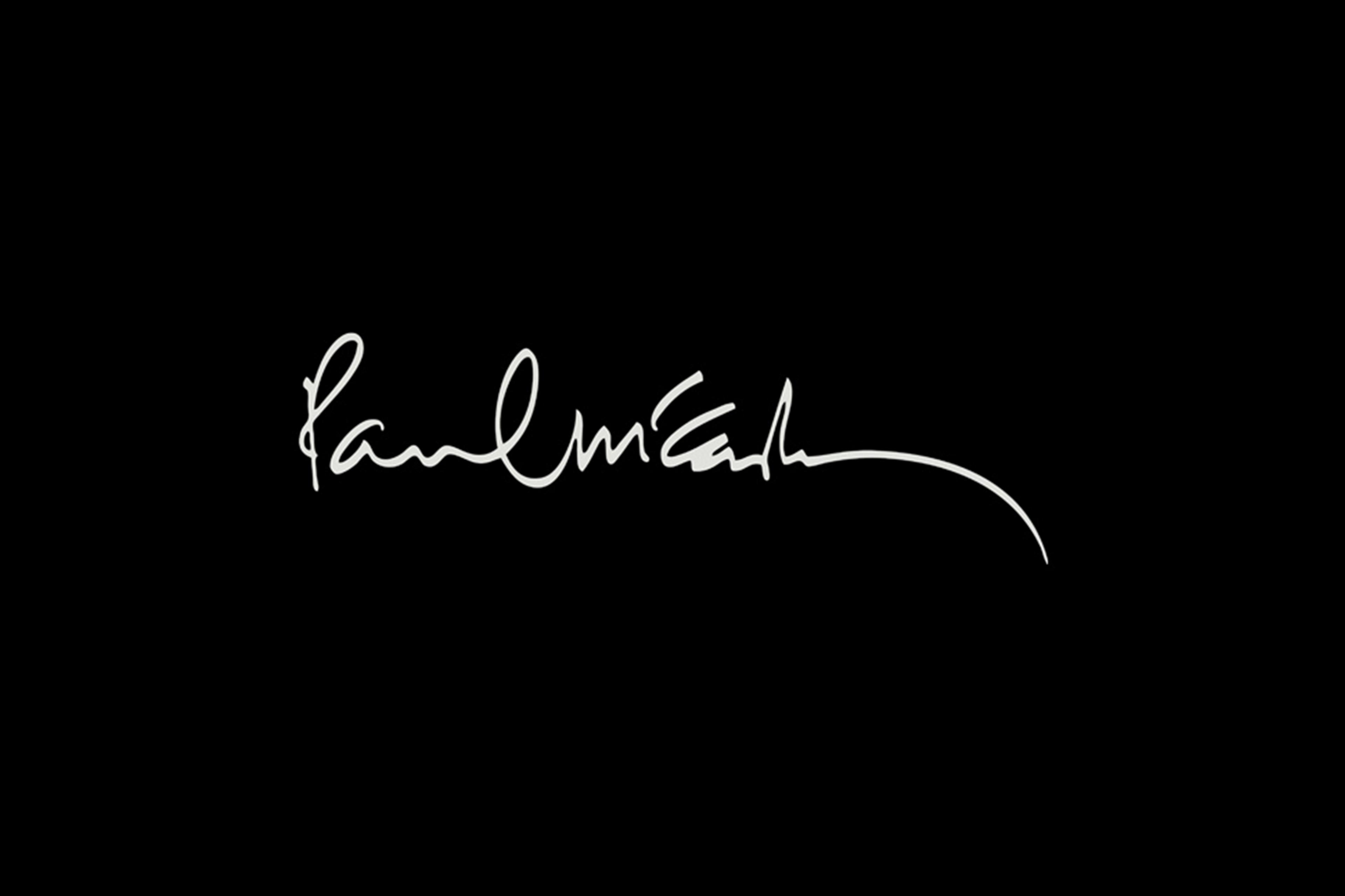 Paul McCartney signature on a black background