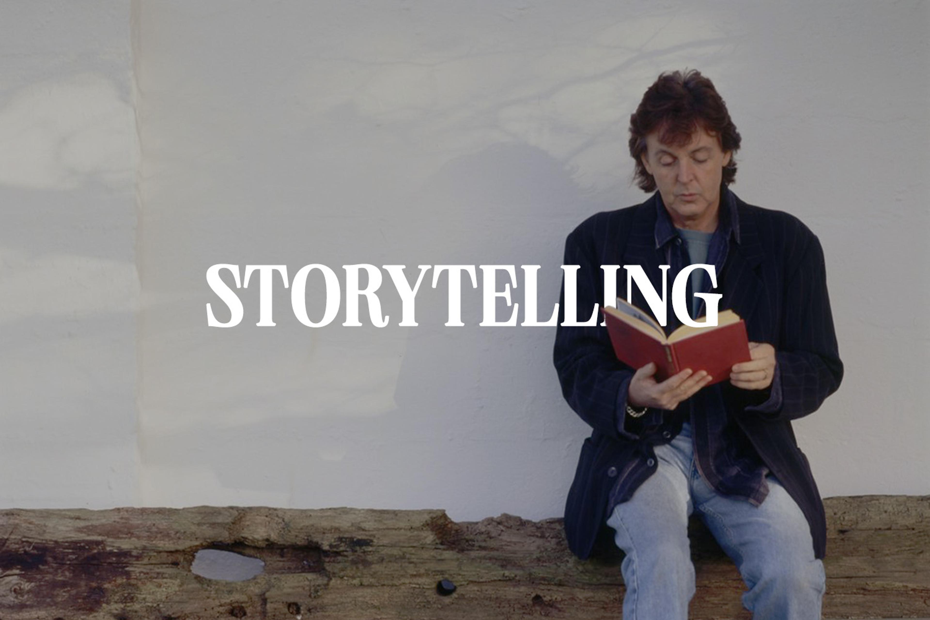 Photo of Paul reading a book with the text 'Storytelling' in the middle overlaid. Used to promote the 'Sticking Out of My Back Pocket' playlist about stories