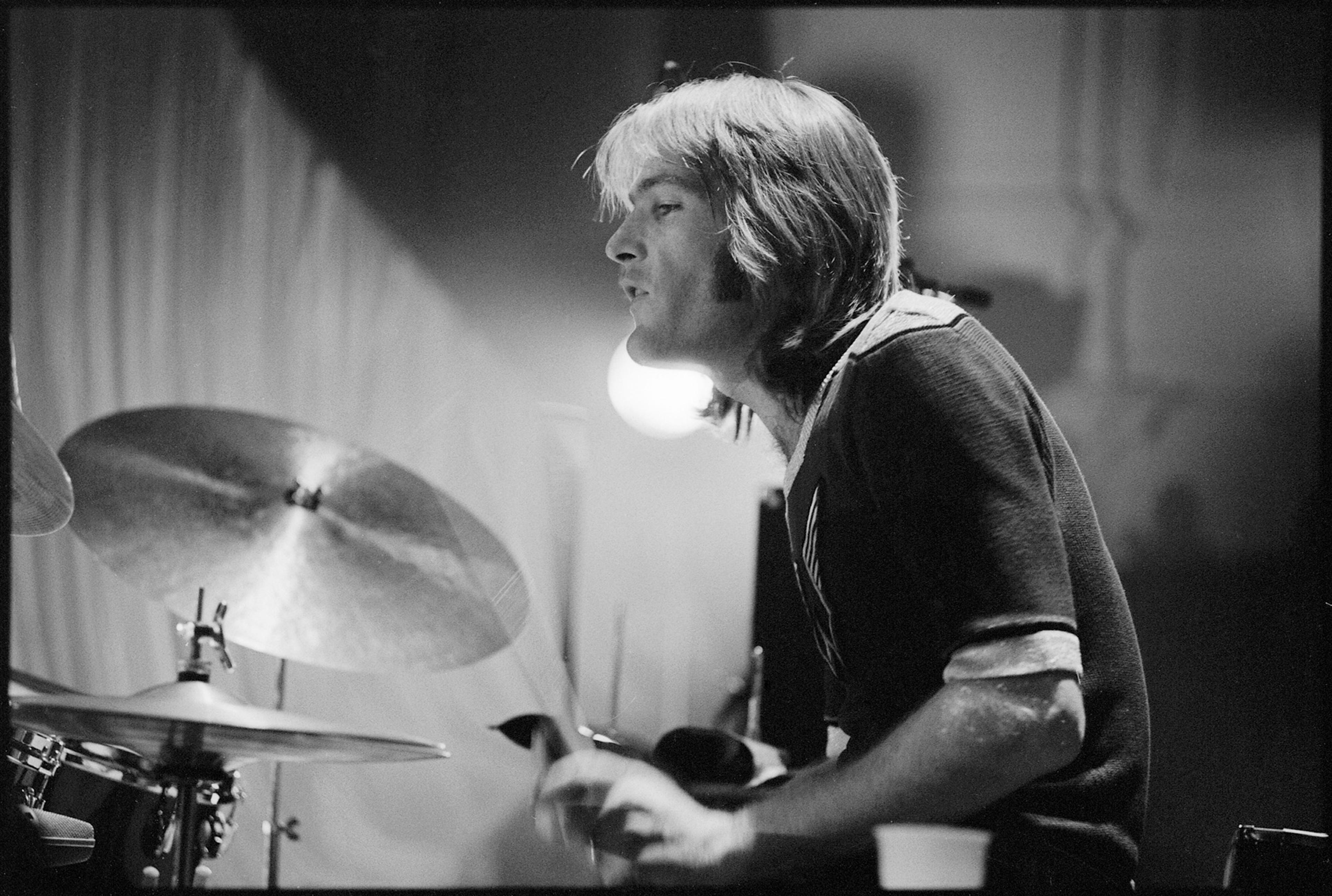 Black and white photograph of Denny Seiwell playing the drums