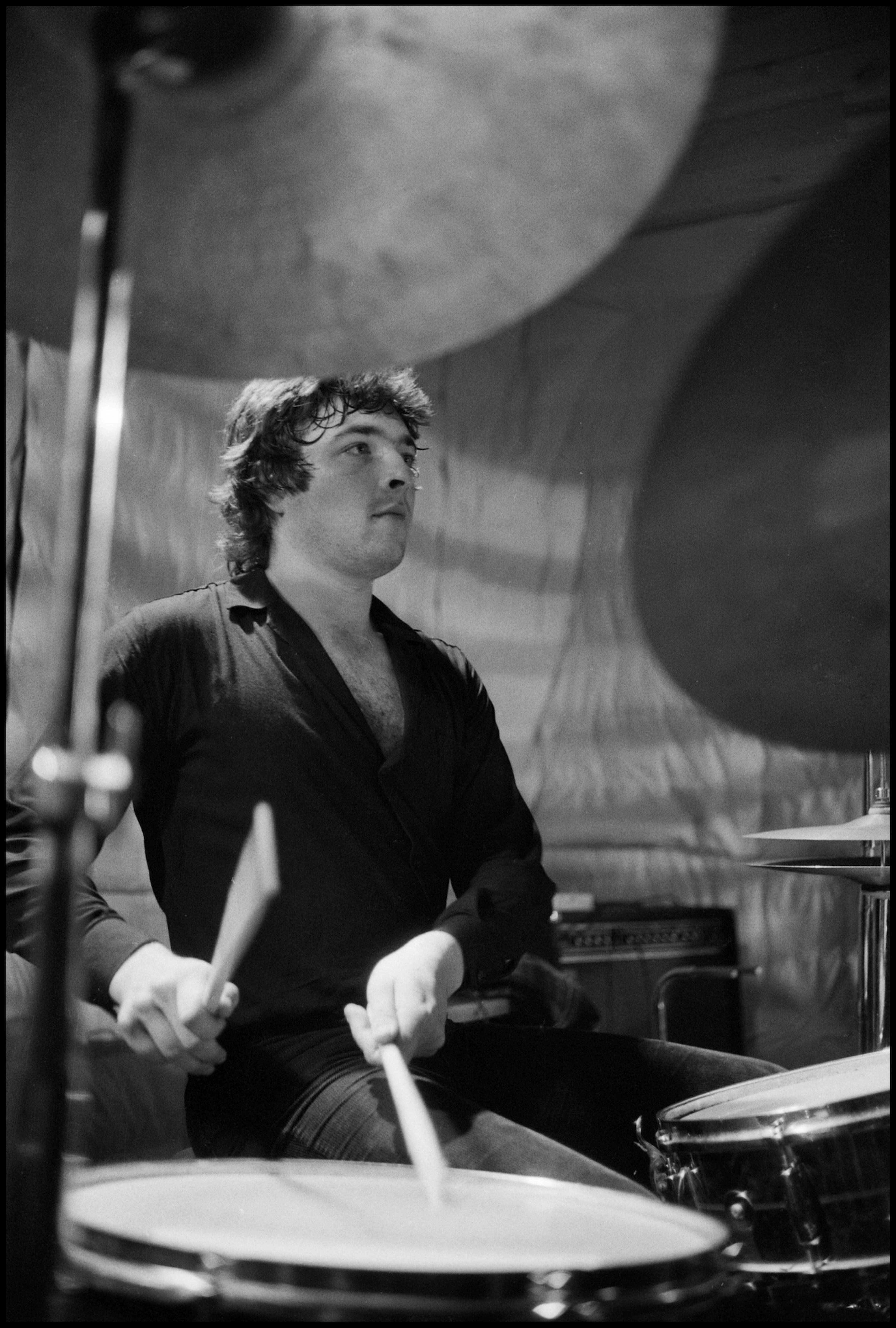 Black and white photograph of Steve Holley at a drum kit