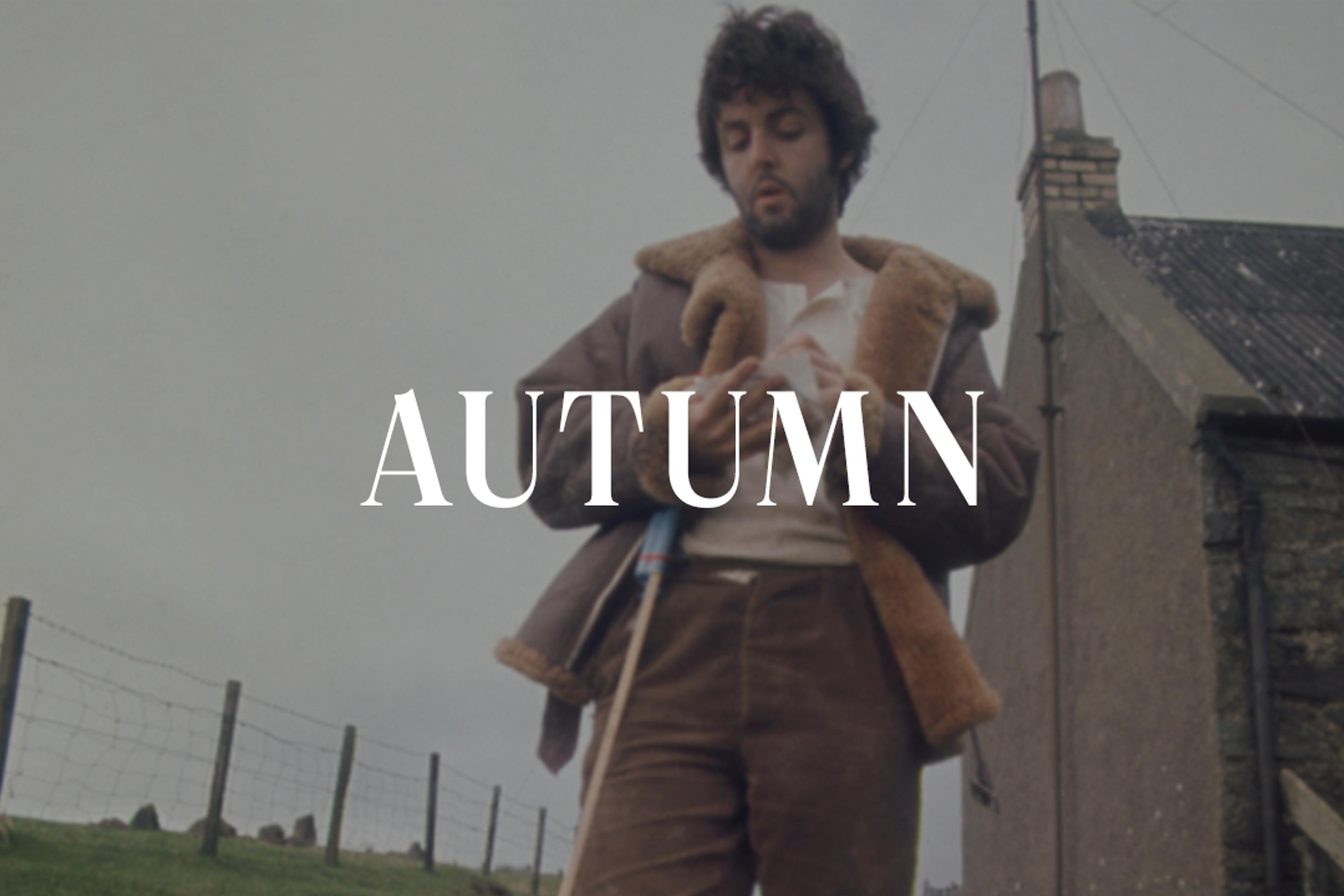 Paul McCartney standing on a farm surrounded by green fields and countryside scenery, with the word "Autumn" displayed across the top of the image.