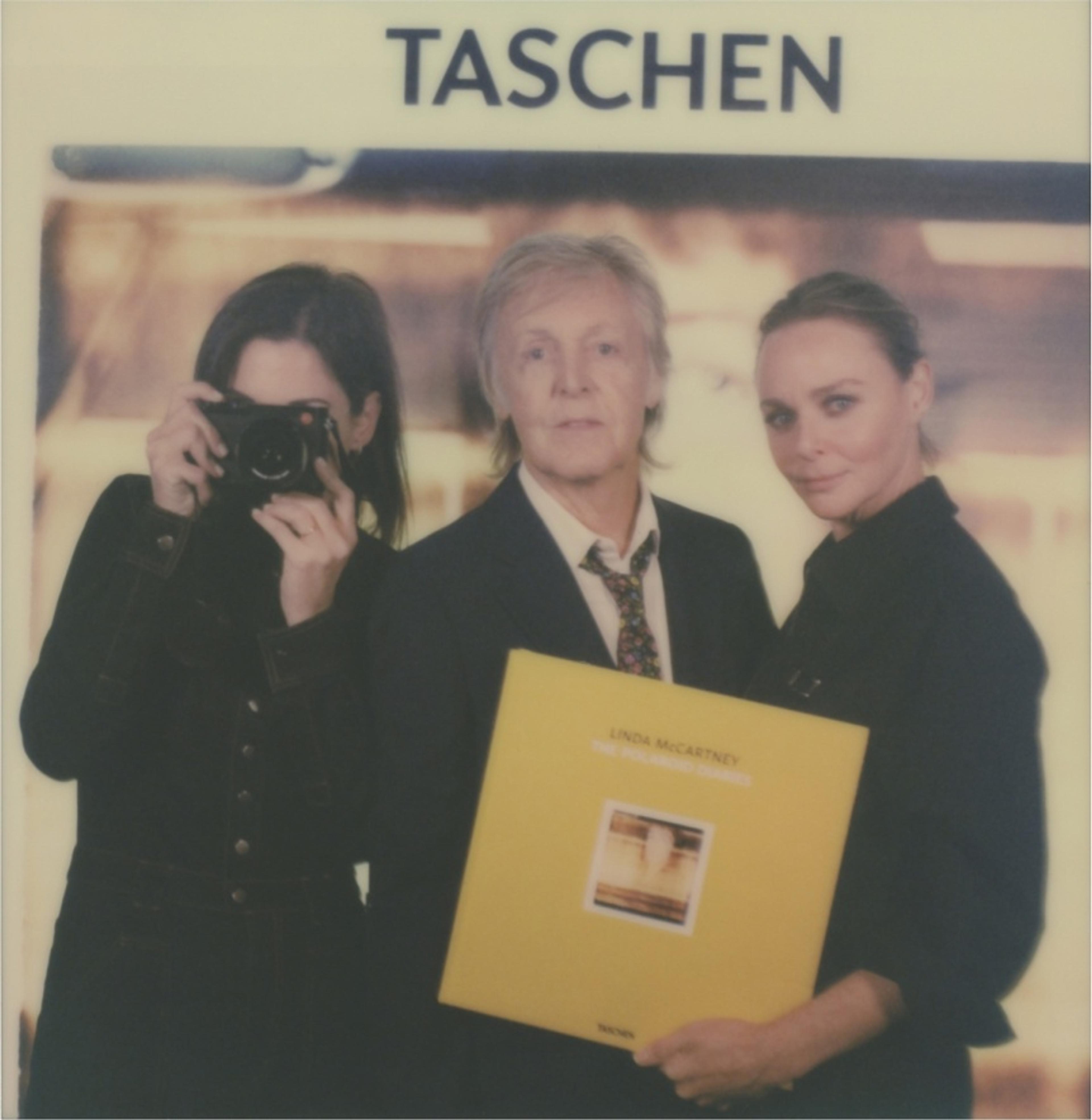 A polaroid of Paul, Mary and Stella McCartney at the launch of 'Linda McCartney: The Polaroid Diaries' book launch at the V&A Museum, London.  