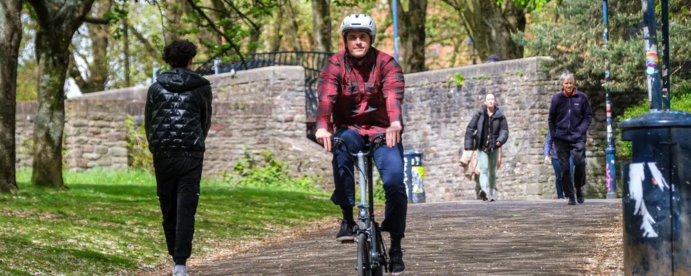 Commuting on a Brompton in a red shirt