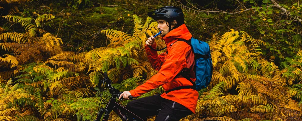 drinking from a hydration pack while riding a bike