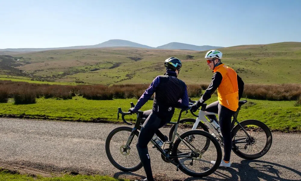 two road cyclists stopping for a chat in the Welsh hills