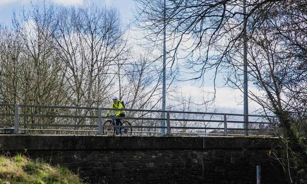 female cyclist on bridge 