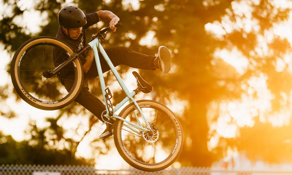 a jump bike does a trick and shows off its tyres