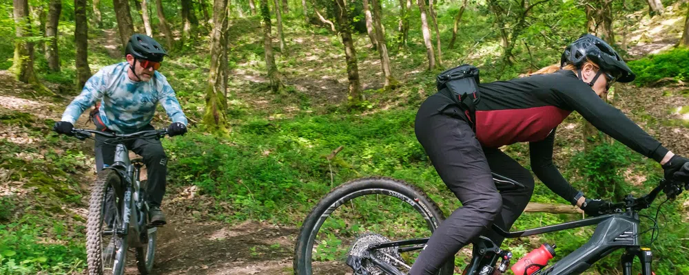 mountain bikers riding with waist packs