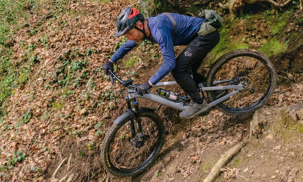 mountain biker riding a tech trail wearing a go pro chest mount