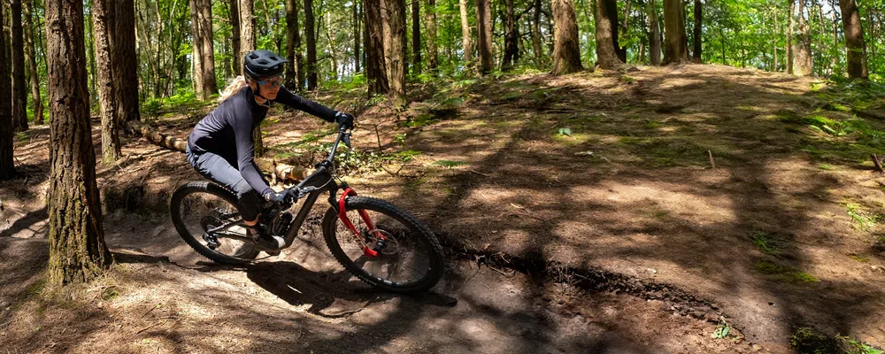 woman getting rad on a full suspension mountain bike - Specialized Stumpjumper Evo