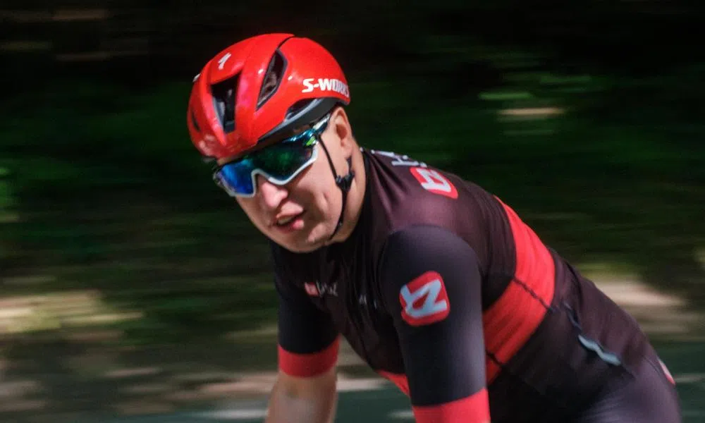 Road cyclist riding while looking a the camera wearing Oakley Sunglasses and an S-Works helmet