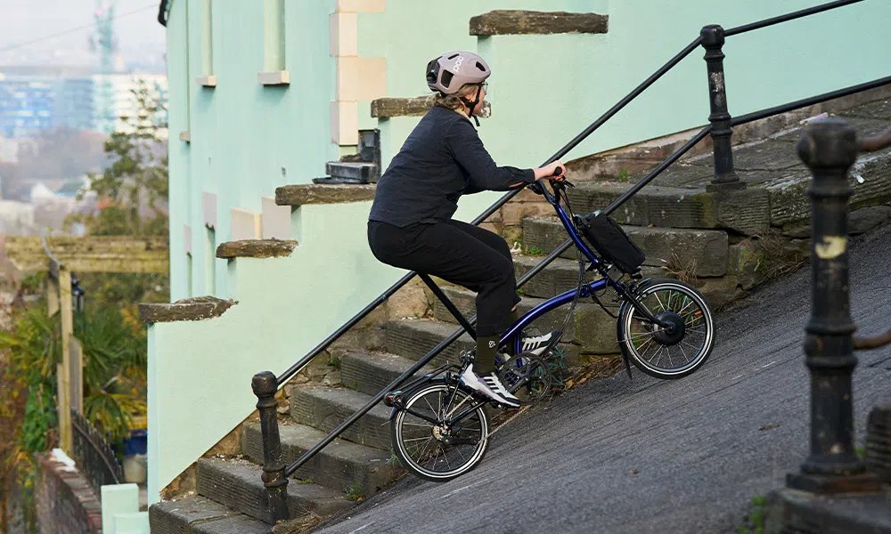 riding an electric folding bike up a steep hill