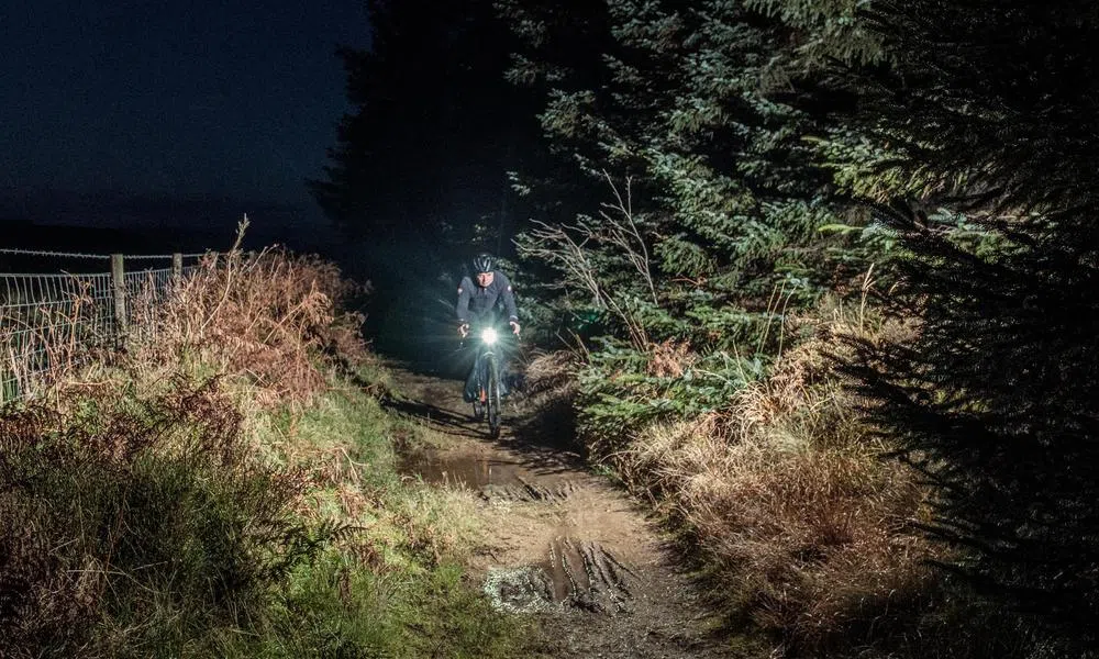 Gravel rider at night using Cateye lights