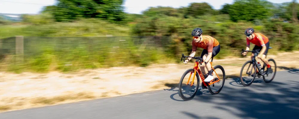 road riders race by at speed