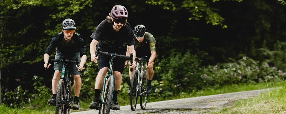 3 gravel riders on gravel road 