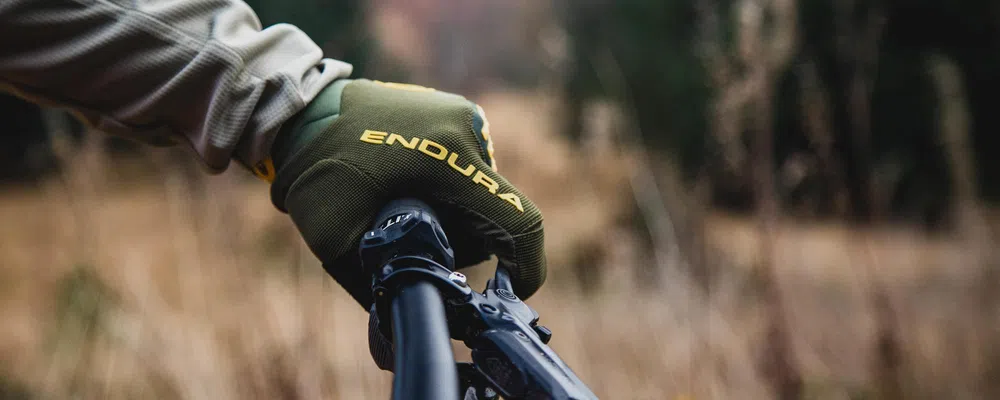 endura mountain bike long finger glove close up modelled in handlebar