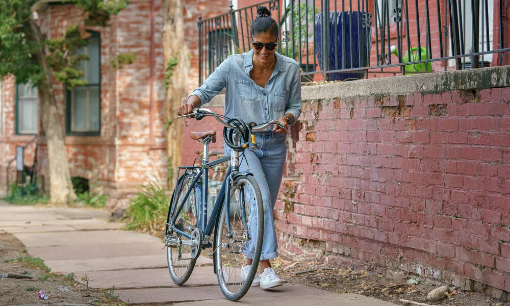 pushing a bike with a cable lock on the handlebars