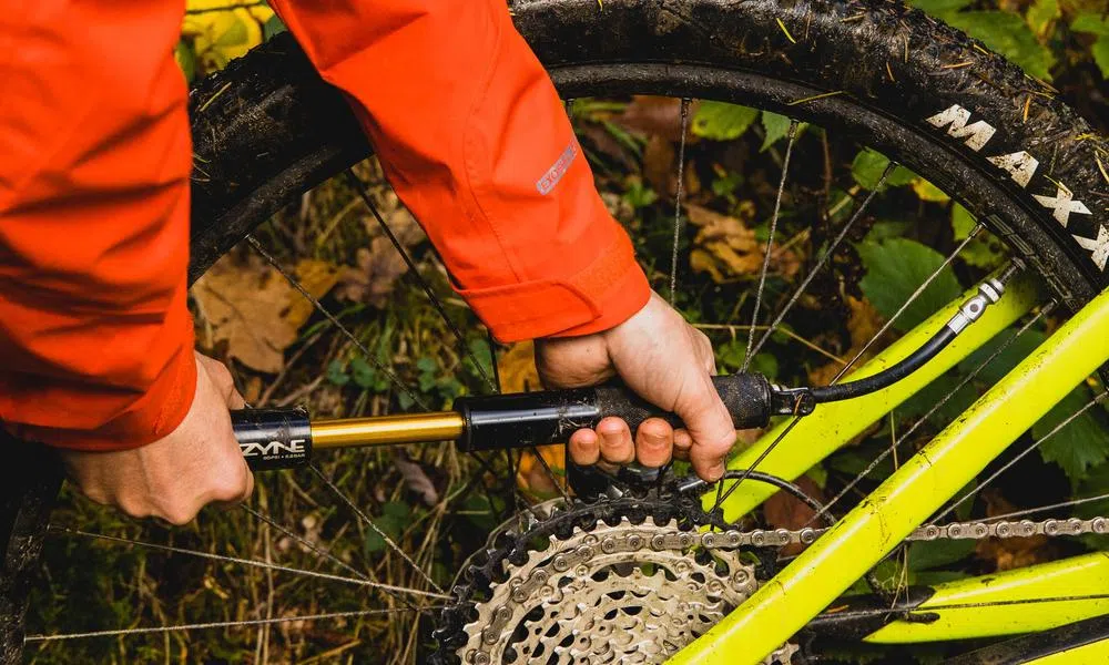 using a hand pump to pump up an mtb tyre