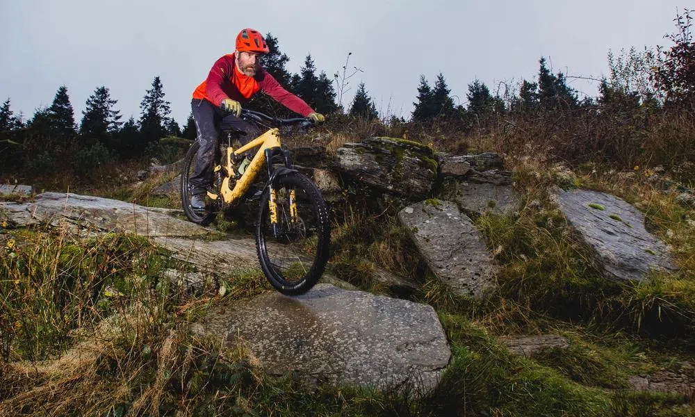 Riding an electric mountain bikes over rocks 