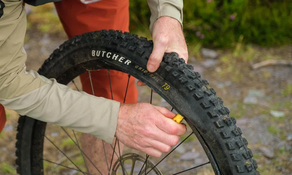 MTB rider repairing a puncture