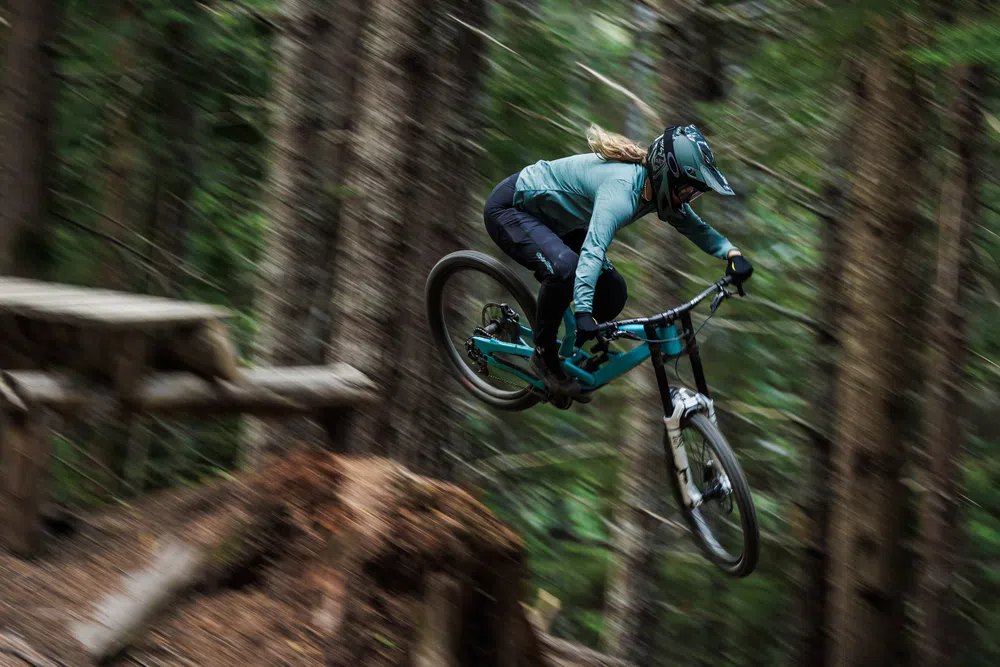 woman riding dh mtb in tld kit