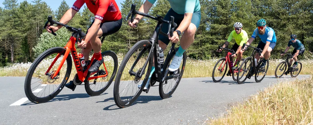 a group of road bikes ride past 