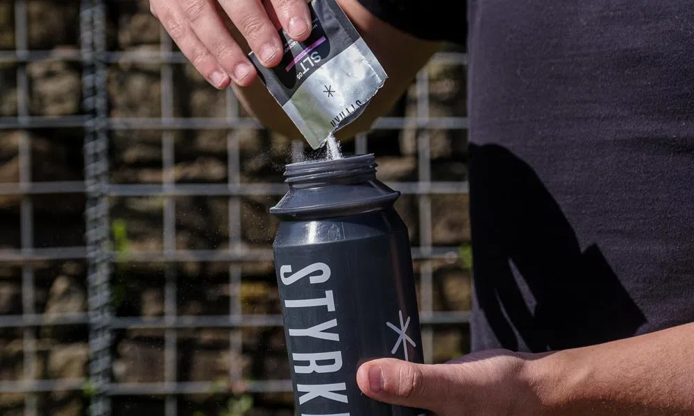 styrkr powder into water bottle