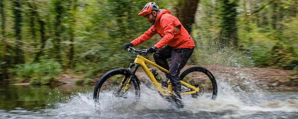 riding through a river on an electric mountain bike