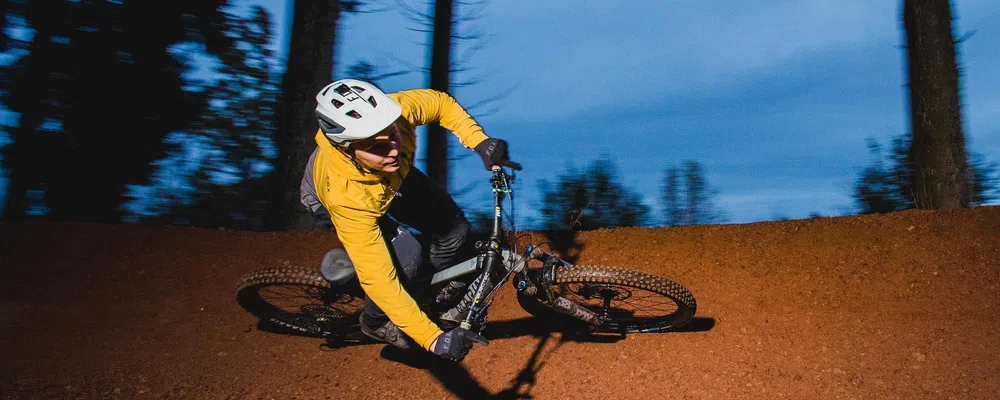 mountain biker railing a berm in fox helmet