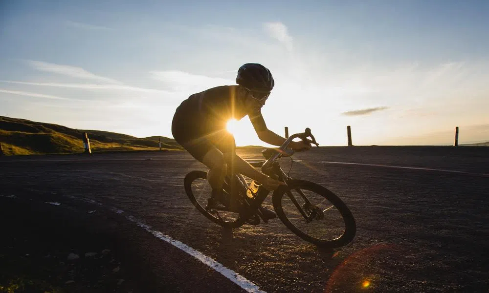 road cyclist cornering at sunset