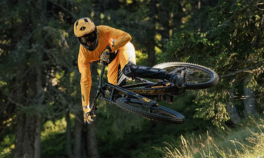 mtb rider styling a jump in Leatt kit