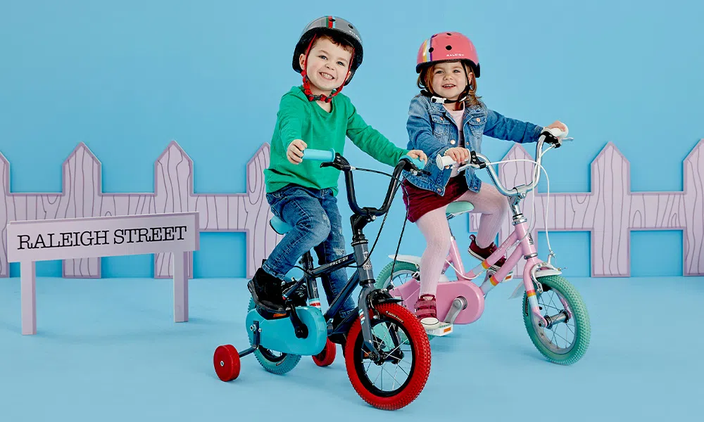 two childern on bikes with stabilizers