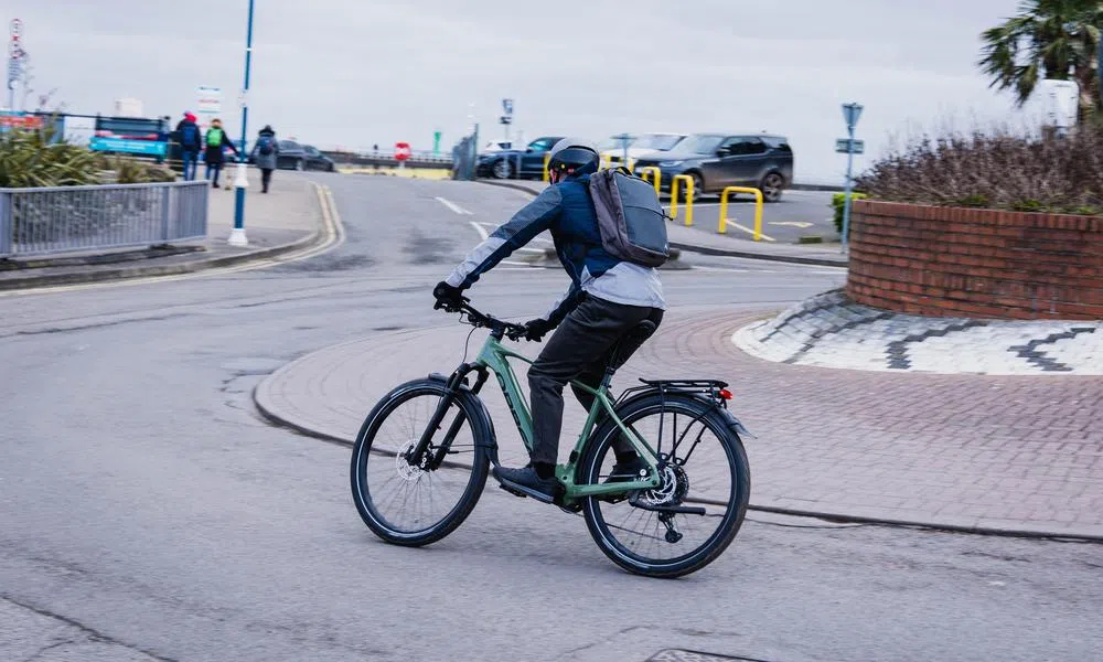 cyclist in urban area on hybrid bike with pannier rack