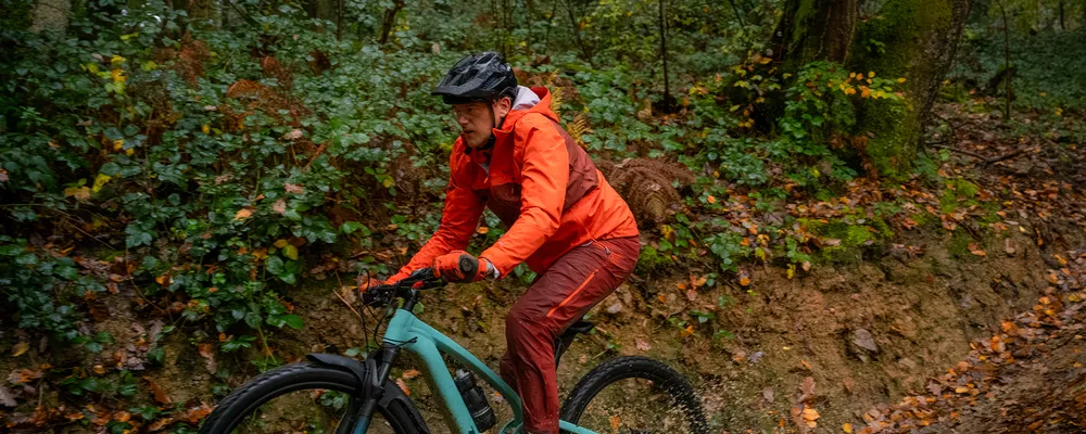 mountain biker riding clyne on a wet winters day