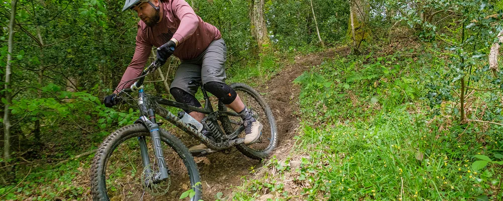 cyclist descending a trail in clyne