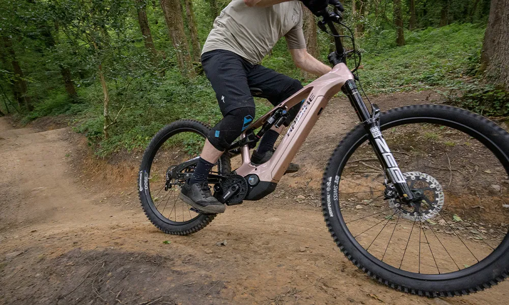 close up electric mountain bike rider with knee pads