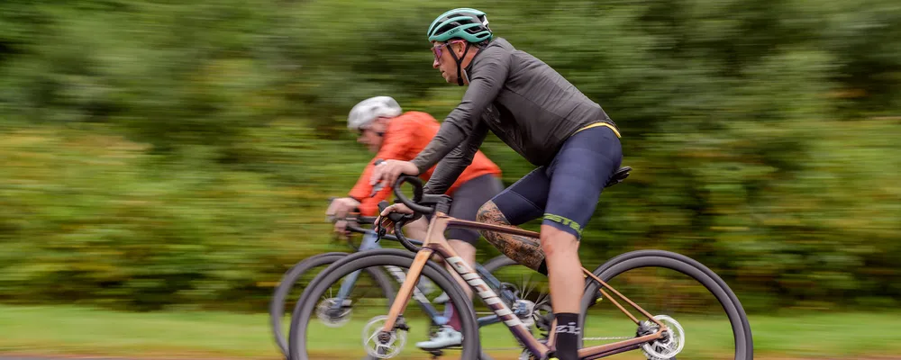 Road cyclist in a grey windproof jacket