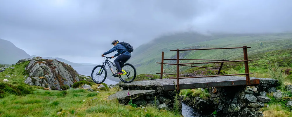 mountain biker riding on a wet day in the hills with waterproof jackets