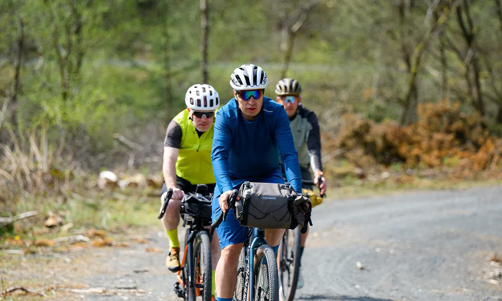 gravel riders pedalling a gravel road in llyn brianne