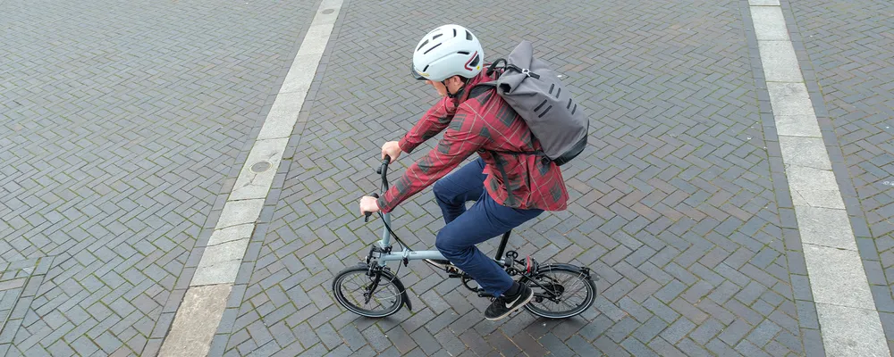 commuter riding a brompton